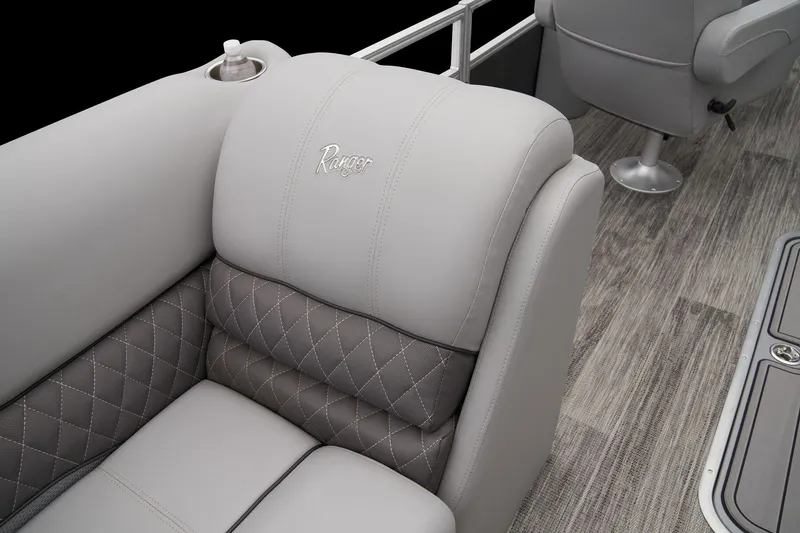 Slide: The Image of 2024 Ranger Reata 223FC boat interior with luxurious gray seating and diamond stitching. - 13
