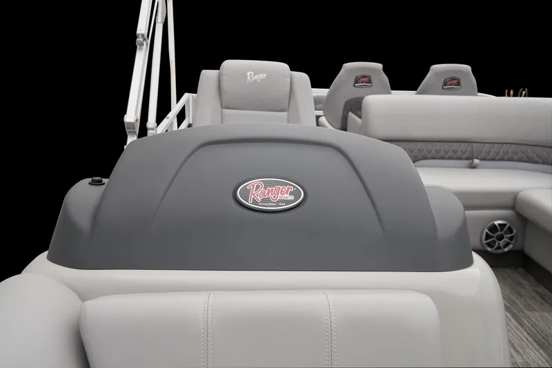 Slide: The Image of 2024 Ranger Reata 223FC boat interior with gray seating and Ranger logo. - 16