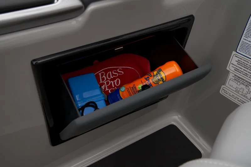 Slide: The Image of Storage compartment in 2024 Ranger Reata 223FC boat with sunscreen and Bass Pro hat. - 36