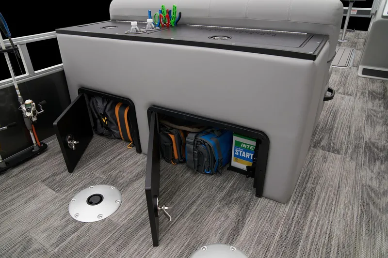 Slide: The Image of 2024 Ranger Reata 223FC storage compartments with fishing gear and accessories. - 48