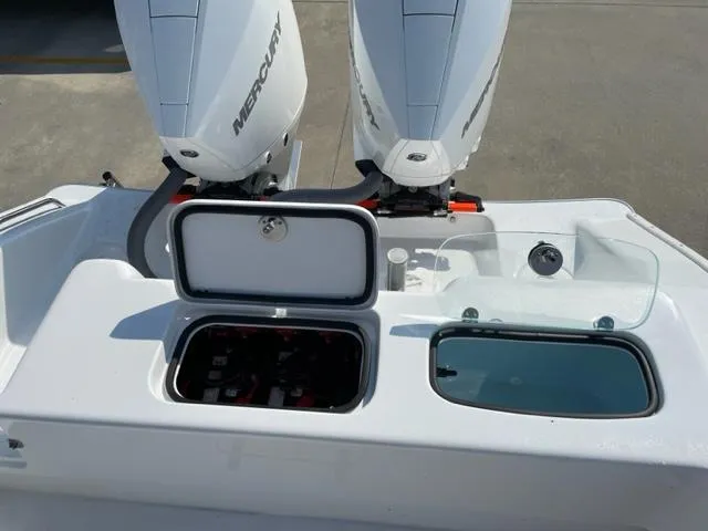 Slide: The Image of 2024 Cape Horn 31T boat with dual Mercury engines and open storage compartments. - 8