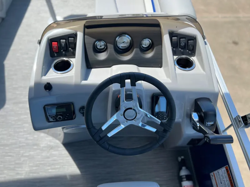Slide: The Image of 2024 Bennington 20 SVSR boat dashboard with steering wheel, gauges, and control panel. - 5