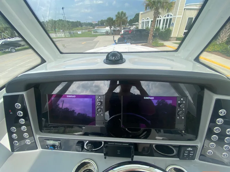 Slide: The Image of 2024 Robalo 266 Cayman boat dashboard with dual Simrad displays. - 15