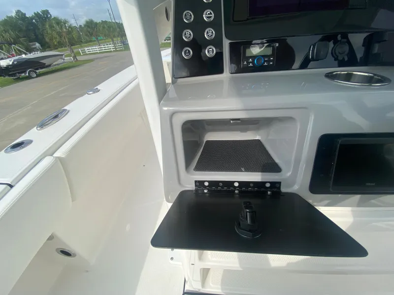 Slide: The Image of 2024 Robalo 266 Cayman boat console with storage compartment and control panel. - 17
