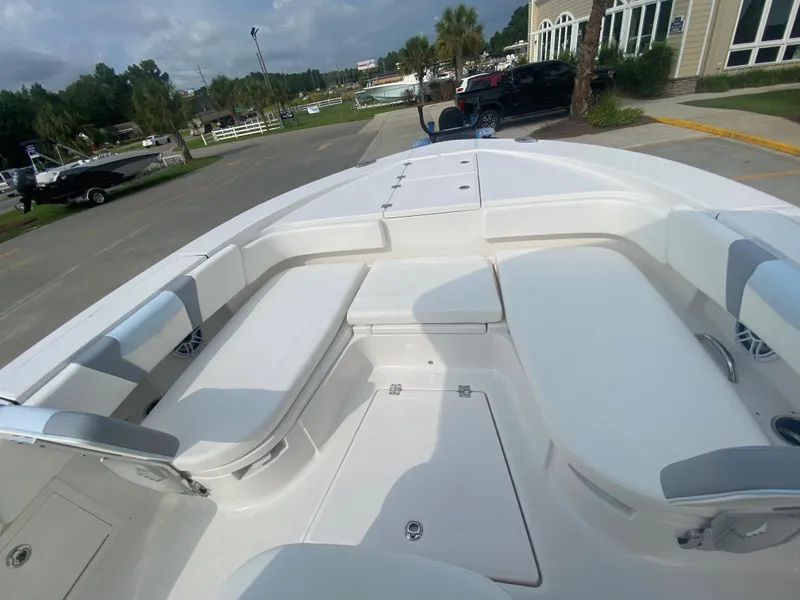 Slide: The Image of 2024 Robalo 266 Cayman boat with spacious seating and storage compartments. - 21