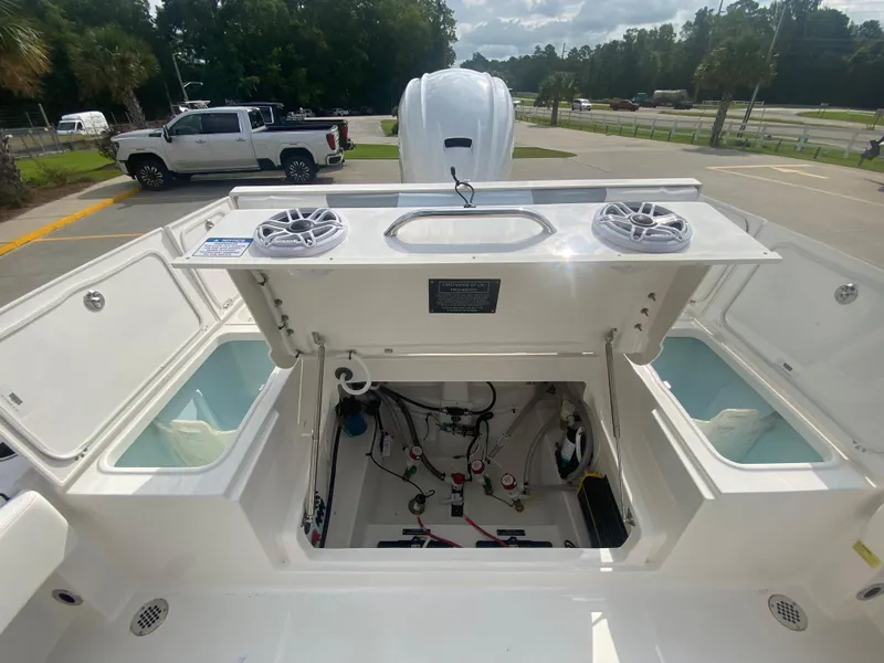 Slide: The Image of 2024 Robalo 266 Cayman boat interior with open compartments and visible wiring. - 9