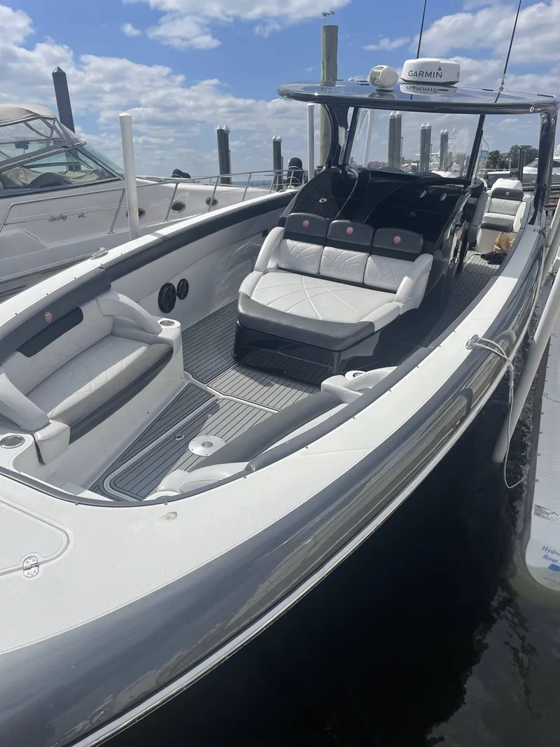 Slide: The Image of 2017 Mystic Powerboats M4200 luxury speedboat docked at marina. - 11