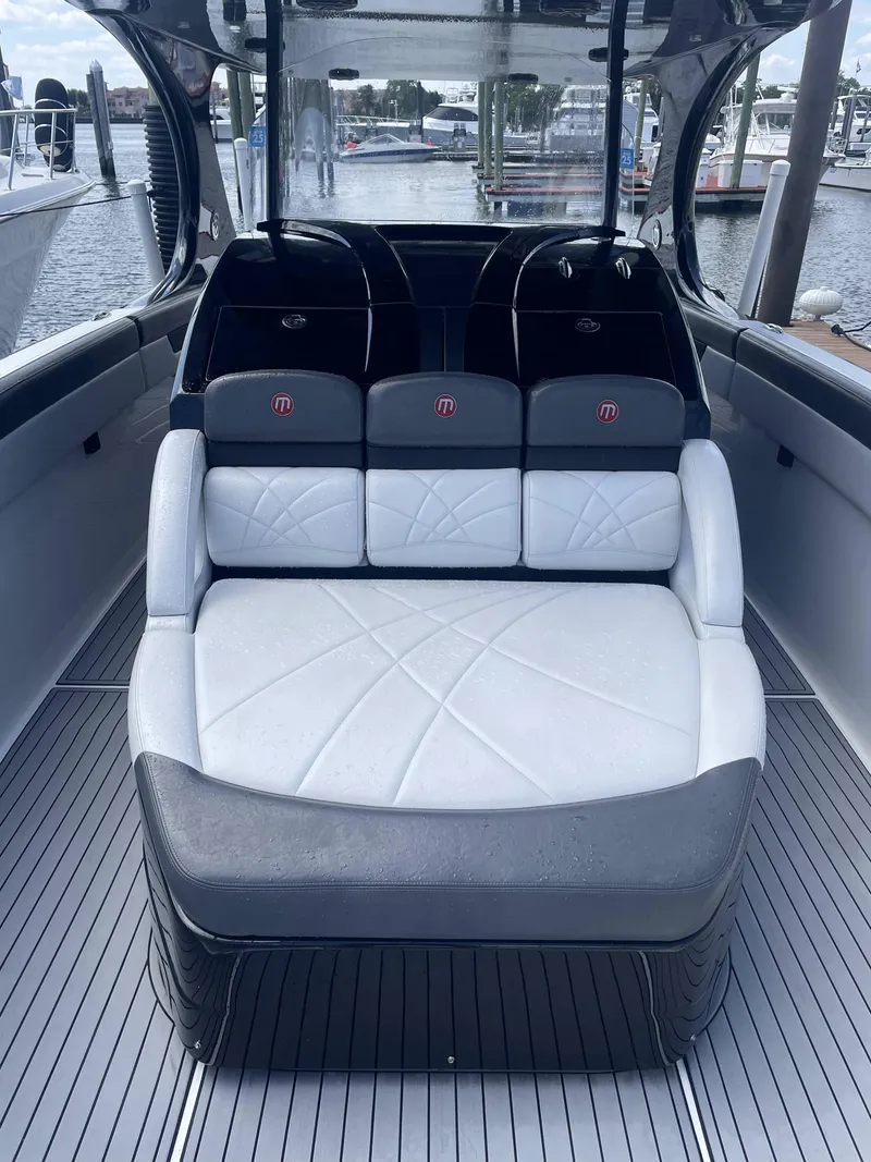 Slide: The Image of 2017 Mystic Powerboats M4200 interior seating with waterfront view. - 13
