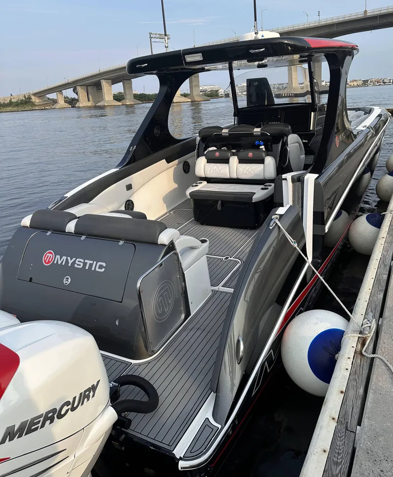 Slide: The Image of 2017 Mystic Powerboats M4200 docked by a bridge. - 5