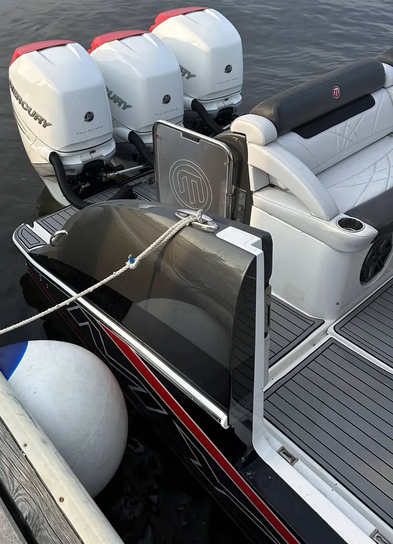 Slide: The Image of 2017 Mystic Powerboats M4200 with triple Mercury outboard engines docked. - 6