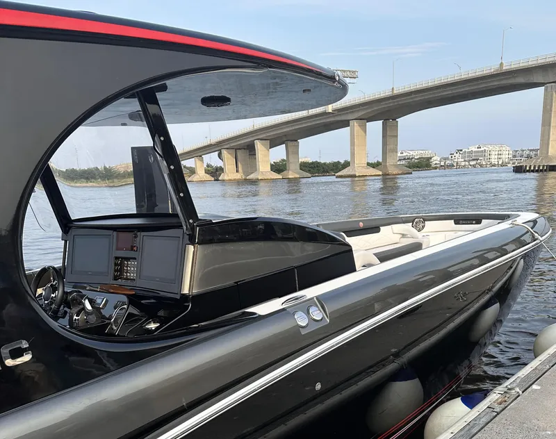 Slide: The Image of 2017 Mystic Powerboats M4200 docked near a bridge on a sunny day. - 8