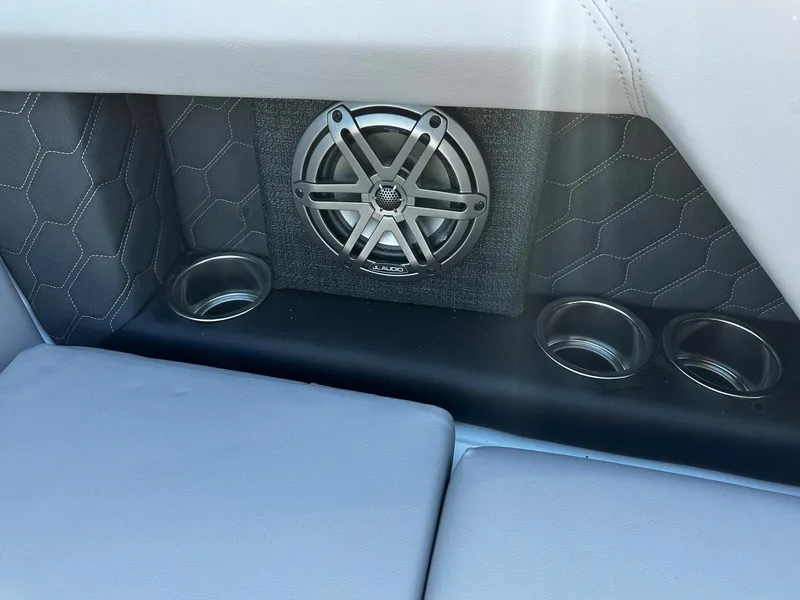 Slide: The Image of 2023 Four Winns H2 boat interior with speaker and cup holders. - 10