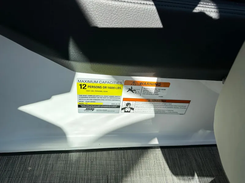 Slide: The Image of 2023 Four Winns H2 boat capacity label, maximum 12 persons or 1600 lbs. - 12