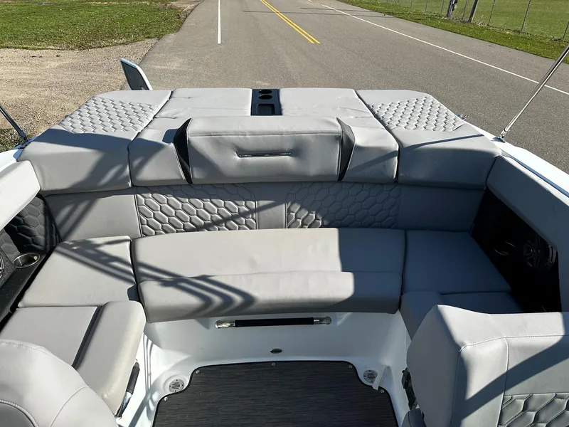 Slide: The Image of 2023 Four Winns H2 boat interior with gray cushioned seating and modern design. - 14