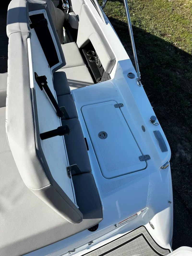 Slide: The Image of 2023 Four Winns H2 boat interior with seating and storage compartment. - 15