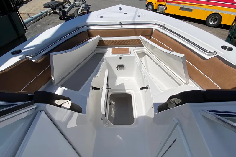 Slide: The Image of 2024 Sea Pro 240 Dual boat with open storage compartments and seating area. - 12