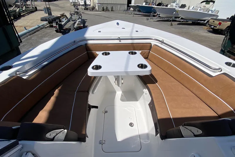Slide: The Image of 2024 Sea Pro 240 Dual boat with brown cushioned seating and a central table. - 13