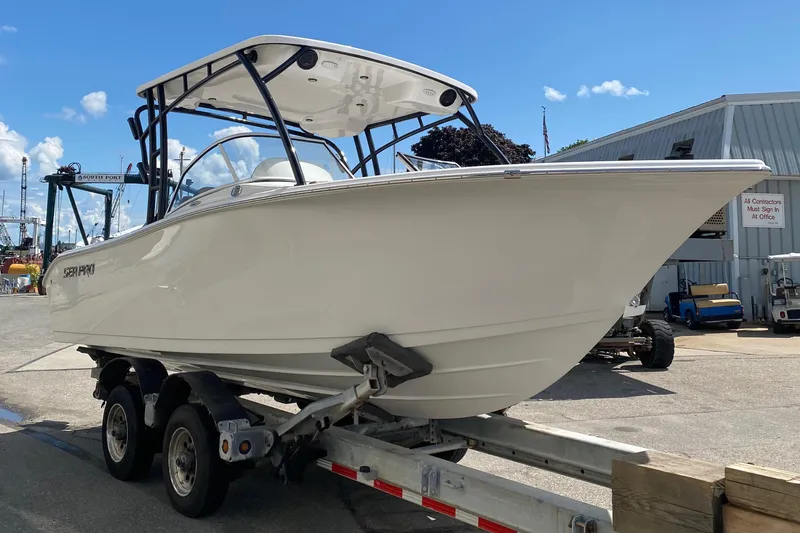 Slide: The Image of 2024 Sea Pro 240 Dual boat on a trailer at a marina. - 3