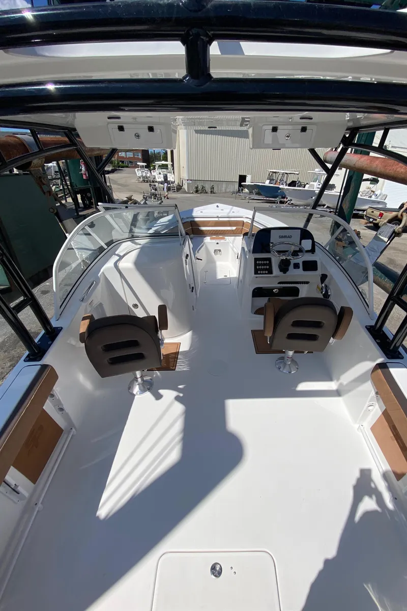 Slide: The Image of 2024 Sea Pro 240 Dual console boat interior with helm and seating. - 4