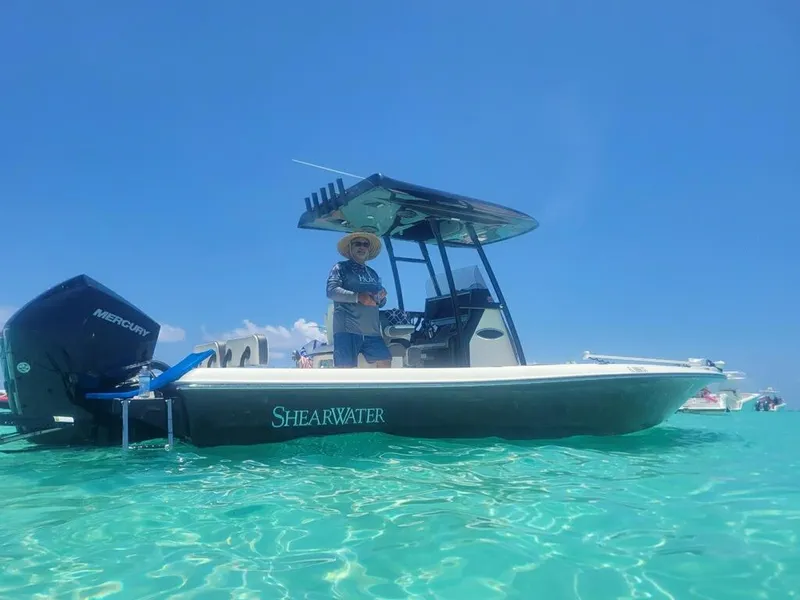 Slide: The Image of 2020 ShearWater 270 Carolina Flare boat on clear water with a person onboard. - 1