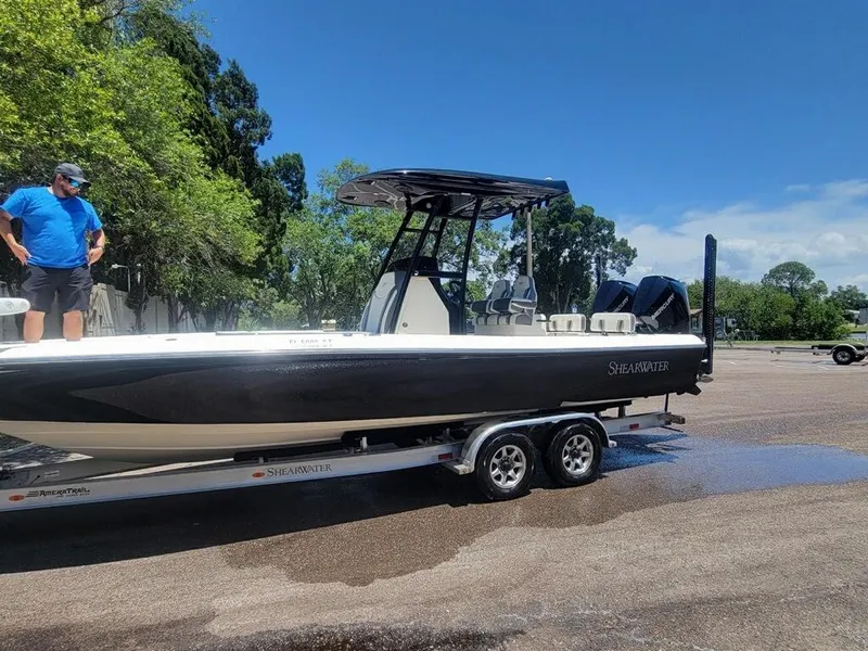 Slide: The Image of 2020 ShearWater 270 Carolina Flare boat on trailer with man standing beside it. - 3