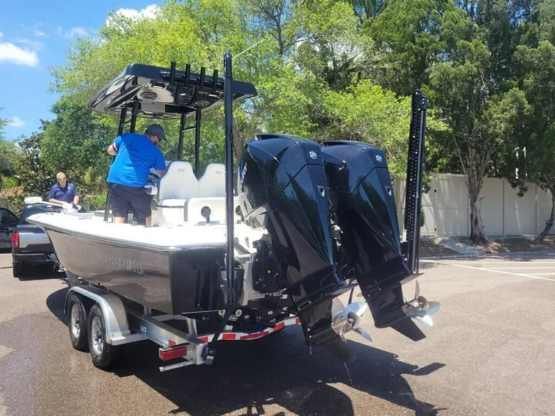 Slide: The Image of 2020 ShearWater 270 Carolina Flare boat on trailer with dual outboard engines. - 4