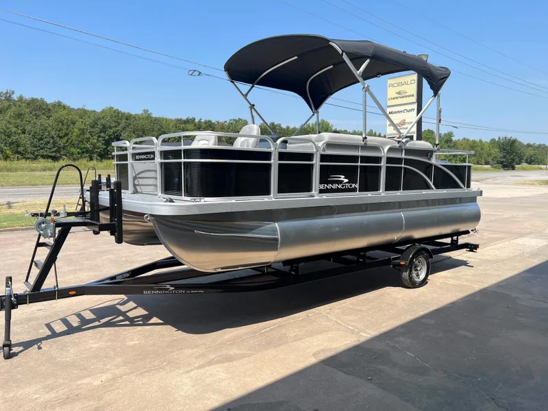 Slide: The Image of 2024 Bennington 20 SVF pontoon boat on a trailer with canopy. - 2