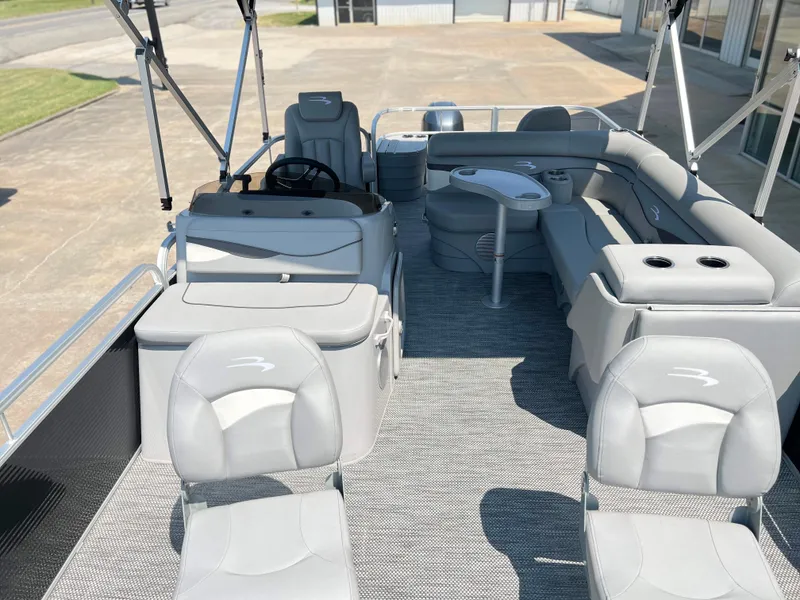 Slide: The Image of 2024 Bennington 20 SVF pontoon boat interior with gray seating and helm. - 7