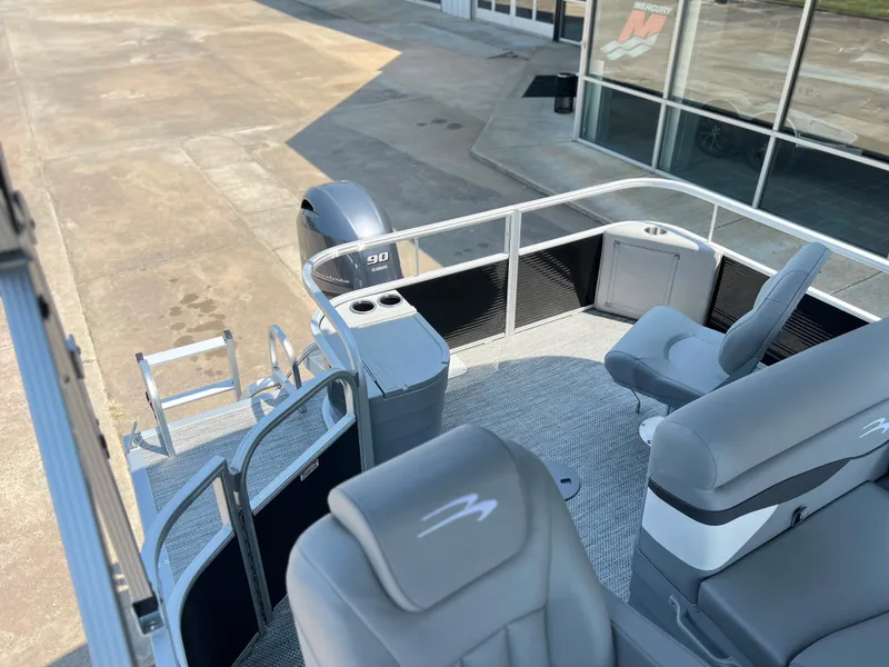 Slide: The Image of 2024 Bennington 20 SVF pontoon boat interior with seating and motor. - 8