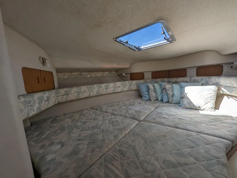 Slide: The Image of Interior cabin of 1992 Sea Ray 330 Express Cruiser with cushions and skylight. - 12