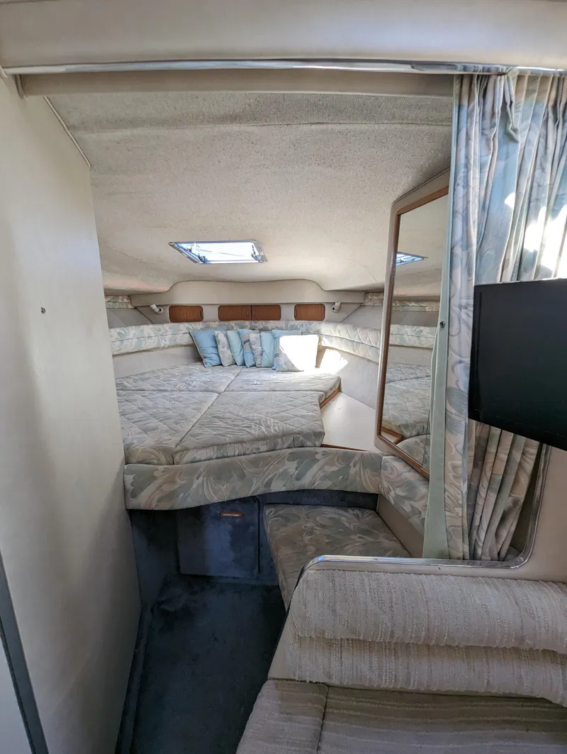 Slide: The Image of Interior of 1992 Sea Ray 330 Express Cruiser with cozy sleeping area and modern amenities. - 13