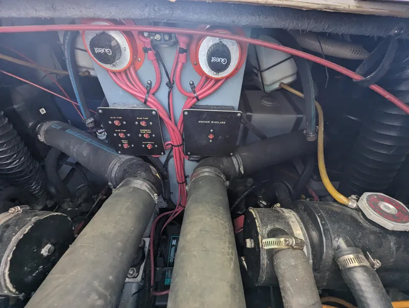 Slide: The Image of Engine compartment of a 1992 Sea Ray 330 Express Cruiser with visible wiring and components. - 14