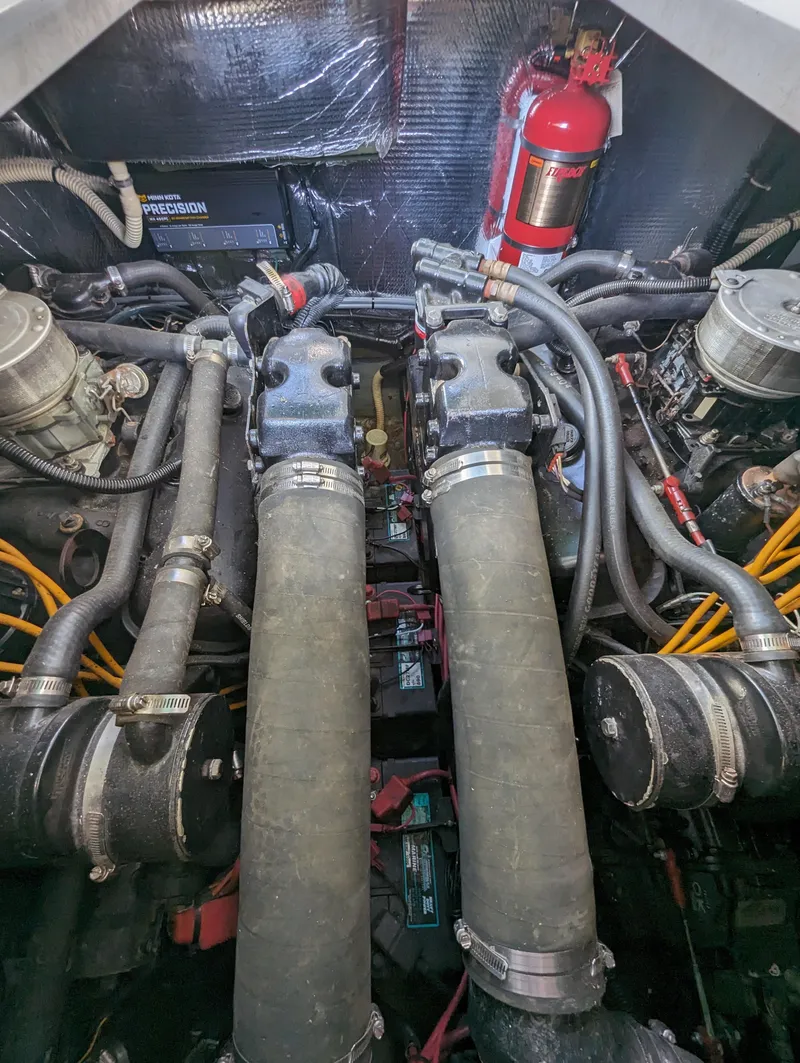 Slide: The Image of Engine compartment of a 1992 Sea Ray 330 Express Cruiser with visible components and fire extinguisher. - 15