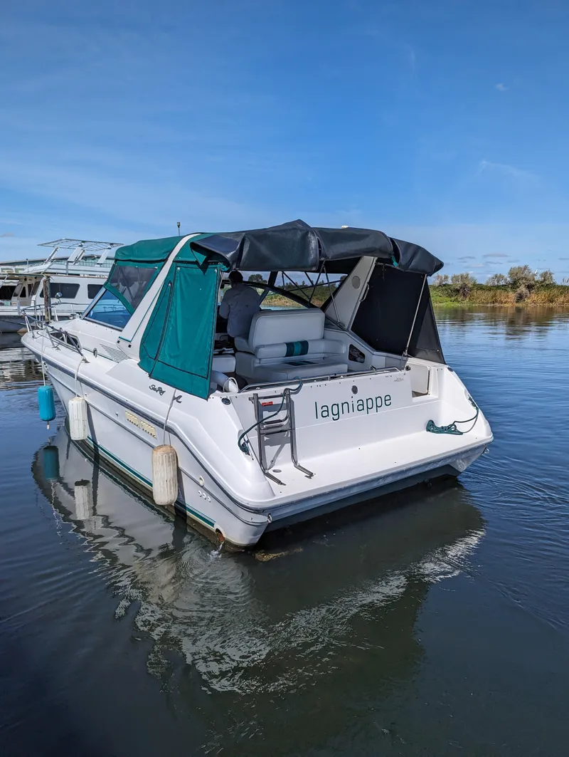 Slide: The Image of 1992 Sea Ray 330 Express Cruiser docked on calm water under clear blue sky. - 3