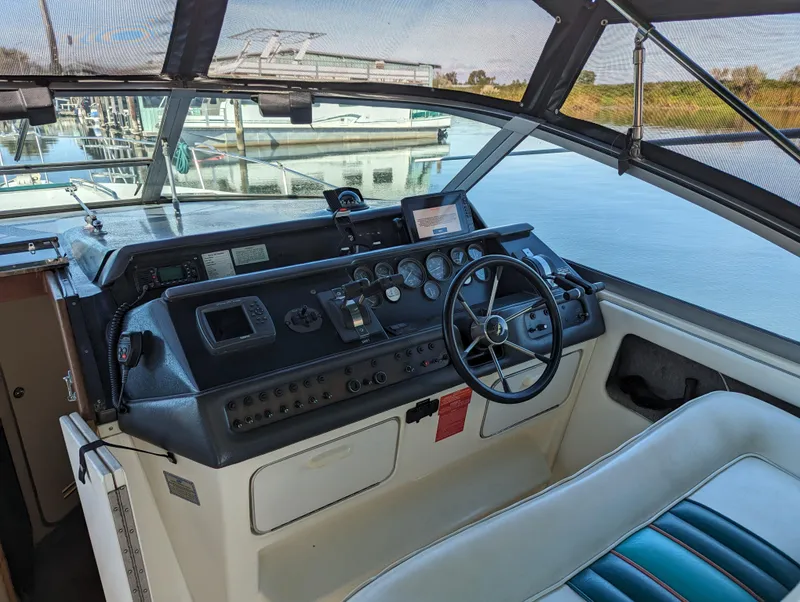 Slide: The Image of Cockpit of 1992 Sea Ray 330 Express Cruiser with steering wheel and control panel. - 6