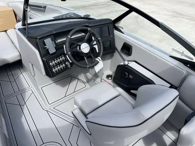 Slide: The Image of 2024 Moomba Craz boat interior with steering wheel and control panel. - 13