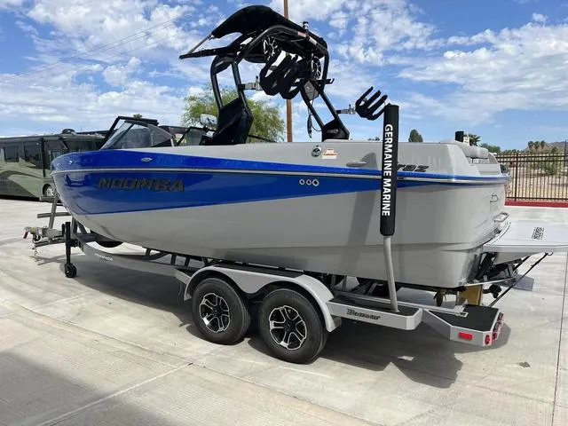Slide: The Image of 2024 Moomba Craz boat on a trailer, featuring a sleek blue and gray design. - 4