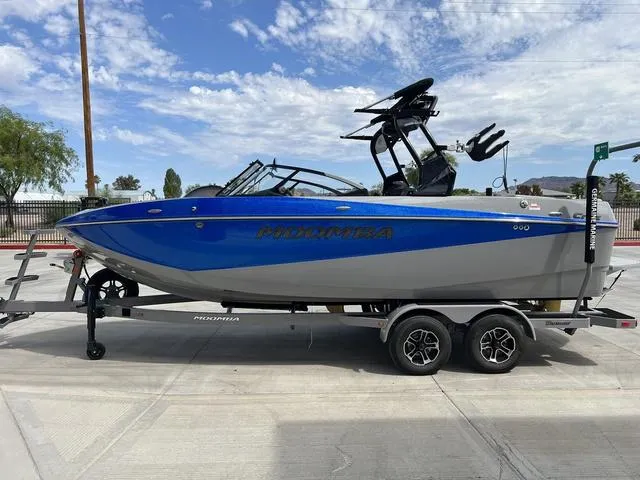 Slide: The Image of 2024 Moomba Craz boat in blue and gray on a trailer. - 5