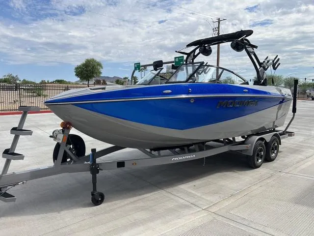 Slide: The Image of 2024 Moomba Craz boat in blue and gray on a trailer. - 6