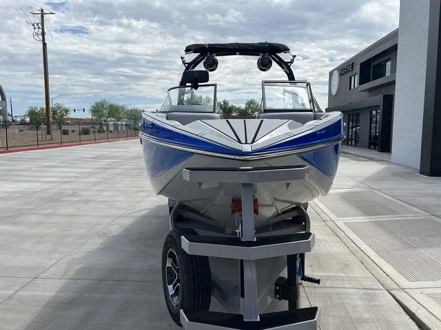 Slide: The Image of 2024 Moomba Craz boat on trailer, front view, parked outdoors. - 7