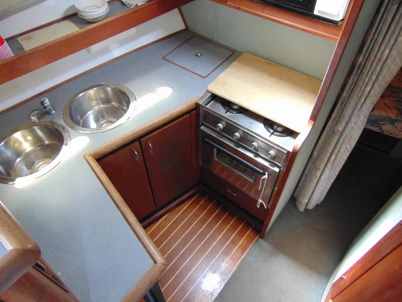 Slide: The Image of 1991 Bayliner 3288 Motoryacht kitchen with dual sinks and compact stove. - 10