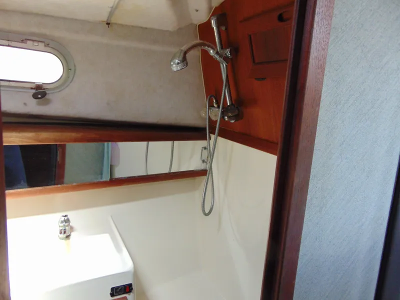 Slide: The Image of 1991 Bayliner 3288 Motoryacht bathroom with shower, sink, and porthole window. - 13