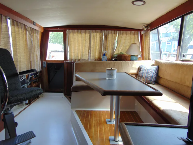 Slide: The Image of Interior of 1991 Bayliner 3288 Motoryacht with cozy seating and dining area. - 14