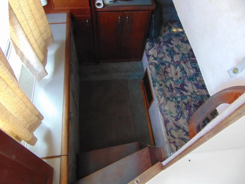Slide: The Image of Interior view of 1991 Bayliner 3288 Motoryacht cabin with stairs and wooden cabinetry. - 15