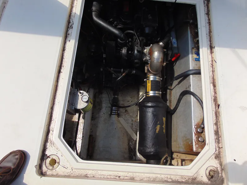 Slide: The Image of Engine compartment of a 1991 Bayliner 3288 Motoryacht, showing mechanical components and piping. - 18