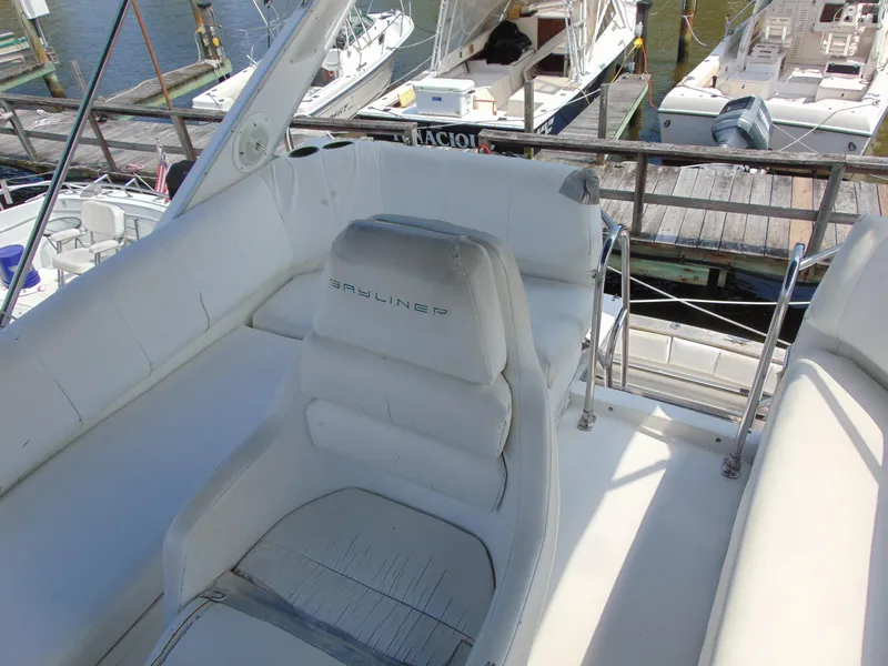Slide: The Image of 1991 Bayliner 3288 Motoryacht cockpit with white seating, docked at marina. - 7