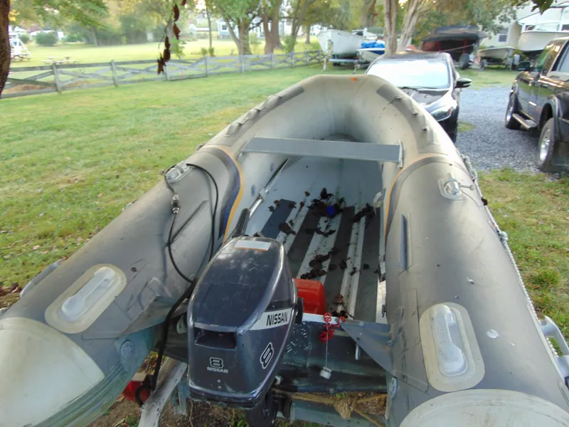 The Image of 2021 North Atlantic Inflatables DINK boat with Nissan motor in grassy yard. - 0