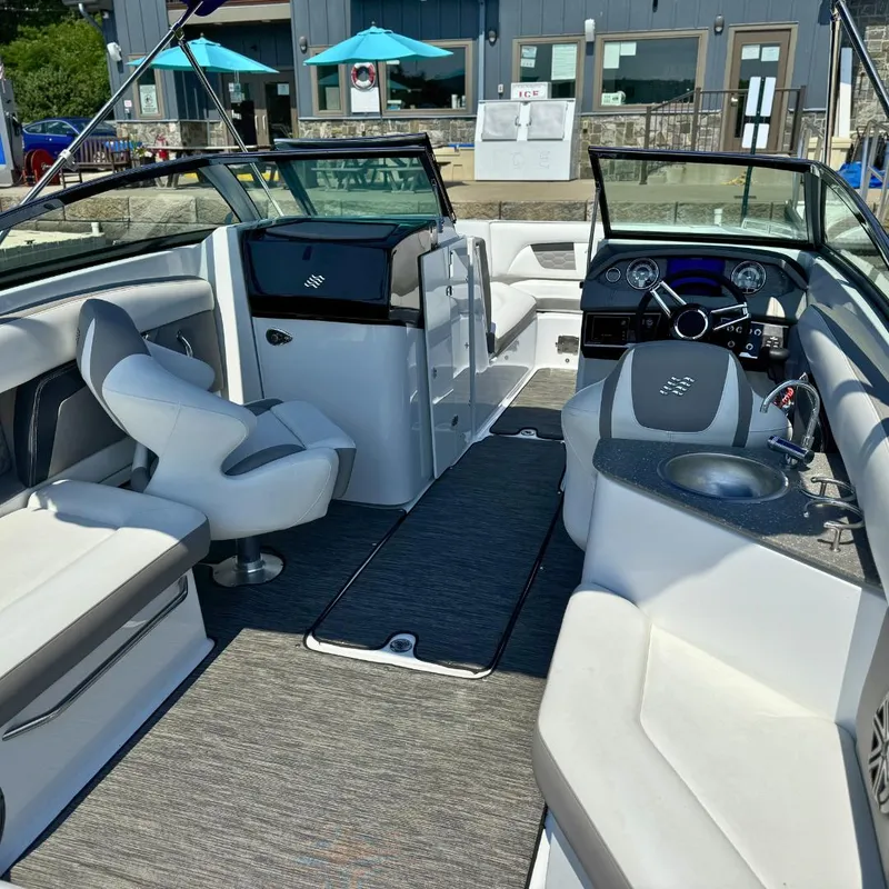 Slide: The Image of 2021 Four Winns HD8 boat docked with blue canopy and spacious seating. - 3