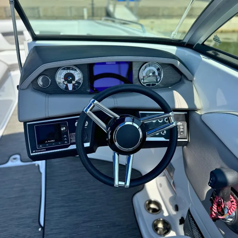 Slide: The Image of 2021 Four Winns HD8 boat interior with seating and dashboard. - 5