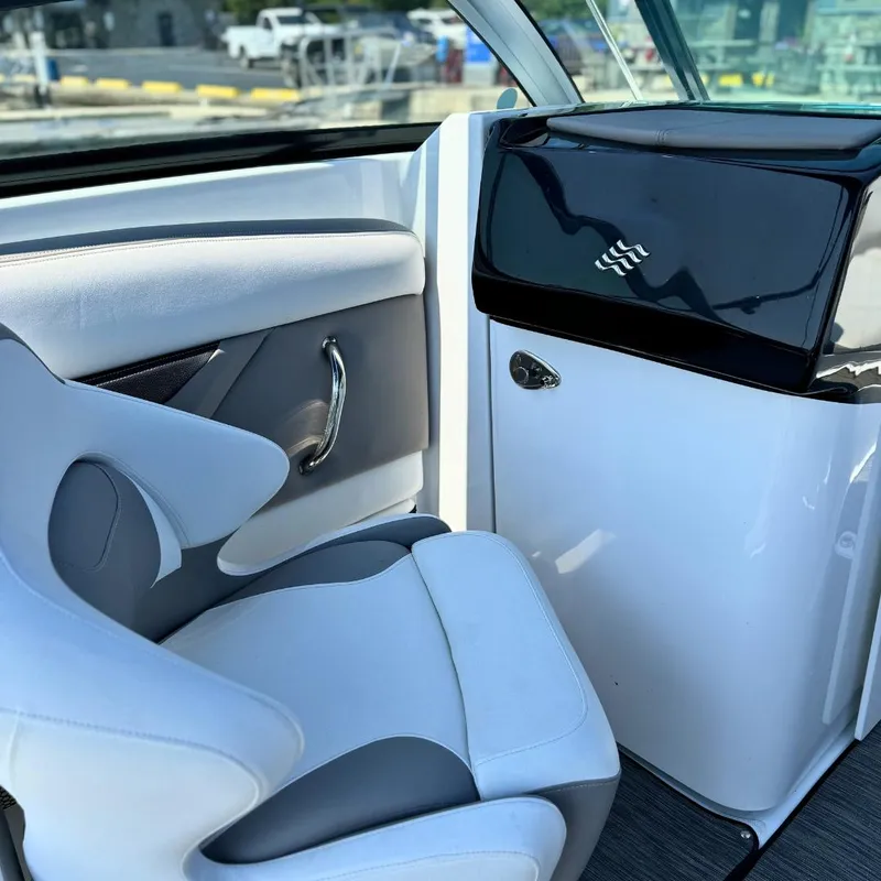 Slide: The Image of 2021 Four Winns HD8 boat with blue canopy docked at a marina. - 9